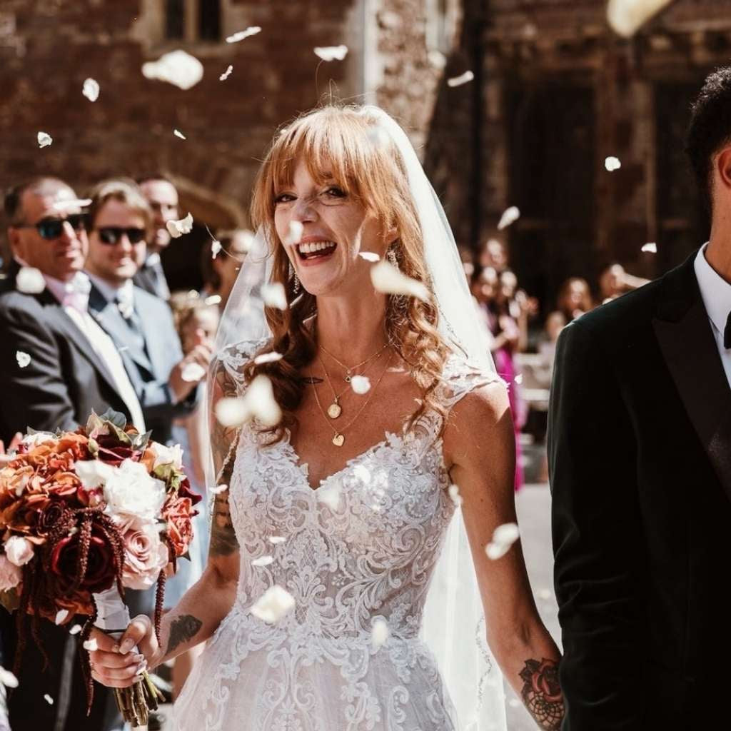Bride celebrating with biodegradable petal confetti toss.