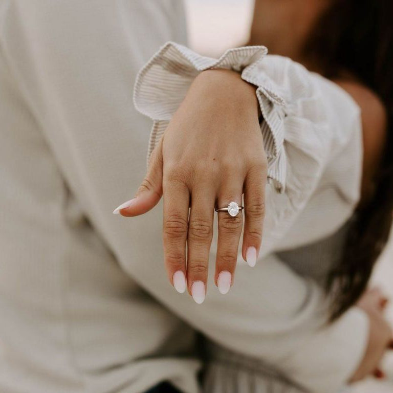 newly engaged couple celebrating with engagement ring close-up