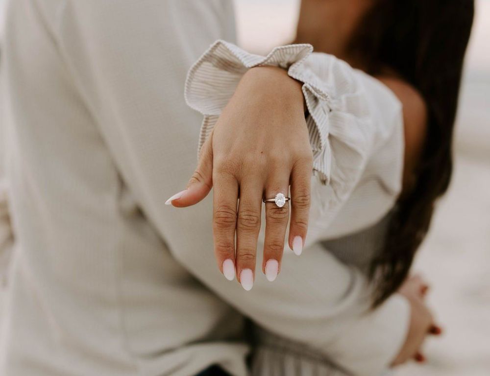 newly engaged couple celebrating with engagement ring close-up