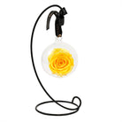 Yellow rose in glass sphere with stand